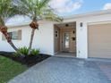 Well-maintained home featuring a neutral color palette, palm tree accents, and a paved driveway at 6300 Midnight Pass Rd # 5, Sarasota, FL 34242