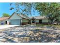 Inviting single-story home showcasing a well-maintained exterior with a two-car garage and a front lawn at 6332 7Th E Ct, Bradenton, FL 34203
