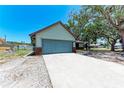 Spacious two-car garage with concrete driveway and a charming single-story home at 6332 7Th E Ct, Bradenton, FL 34203