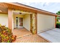 Inviting front entrance featuring a brick pathway, stone accents, and a well-maintained two-car garage at 8402 13Th Nw Ave, Bradenton, FL 34209