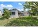Landscaped front yard of single Gathering home with stone accents on the facade at 8413 Lincolnshire Dr, Hudson, FL 34667
