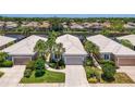A stunning aerial view of the home nestled between serene canals, showcasing lush landscaping and a peaceful neighborhood at 8731 52Nd E Dr, Bradenton, FL 34211