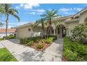 Inviting exterior featuring desert landscaping, a tile roof and attached two-car garage at 9635 Discovery Ter, Bradenton, FL 34212