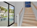 Interior view of staircase leading to the backyard with a pool at 103 4Th N St # A, Bradenton Beach, FL 34217
