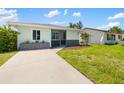 Cozy home featuring an easy concrete driveway and green grass, nestled in a sunny locale at 1040 Hope St, Venice, FL 34285