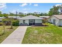Inviting one-story home featuring a well-maintained lawn and a concrete driveway at 1040 Hope St, Venice, FL 34285