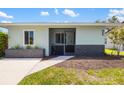 Inviting home with a quaint covered porch, decorated with a rock facade at 1040 Hope St, Venice, FL 34285