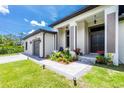 A charming single Gathering home with well manicured landscaping around the front entrance and a concrete driveway at 11960 De Leon Dr, North Port, FL 34287