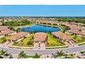 Stunning aerial view of community with a central lake and tile-roofed homes in a circular arrangement at 12230 Amica Loop, Venice, FL 34293