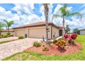 Beautiful exterior view of home with a paver driveway and well-maintained landscaping at 12230 Amica Loop, Venice, FL 34293