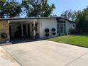 Well-maintained single-story home with a spacious carport and attractive front yard landscaping at 1801 Marilyn Ave, Bradenton, FL 34207