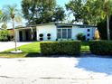 Stylish single-story home with a well-kept lawn, modern accents, and neatly trimmed hedges adding to its curb appeal at 1801 Marilyn Ave, Bradenton, FL 34207
