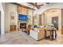 Inviting living room boasts a stone fireplace, wood beams, and elegant archways at 1813 Boyce St, Sarasota, FL 34239