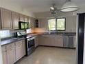Bright kitchen with stainless steel appliances, light wood cabinets and a sunlit window at 191 Maria Ct, Punta Gorda, FL 33950