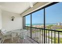 Relax and enjoy the view from this balcony with black railings and comfortable white wicker seating at 2045 Gulf Of Mexico Dr # M1-515, Longboat Key, FL 34228