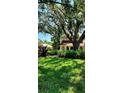 Beautifully landscaped front yard with mature trees offering plenty of shade at 219 24Th W St, Bradenton, FL 34205