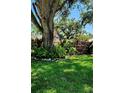 Lush front yard with beautiful foliage and landscaping enhancing the property's curb appeal at 219 24Th W St, Bradenton, FL 34205