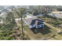 Aerial view of a home surrounded by lush greenery and neighboring houses, showcasing a peaceful setting at 2323 Zuyder Ter, North Port, FL 34286