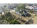 Aerial view of a home nestled among trees and greenery, highlighting its location in a serene environment at 2323 Zuyder Ter, North Port, FL 34286