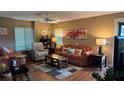 Inviting living room with comfortable seating, a ceiling fan, and natural light from the windows at 2841 74Th St W # 2841, Bradenton, FL 34209