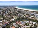 Expansive aerial view showcasing the neighborhood, nearby beach, and scenic waterfront property at 30 Island Cir, Sarasota, FL 34242