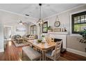 Elegant dining room with hardwood floors, decorative lighting, and a cozy fireplace at 301 W South Ave, Tampa, FL 33603