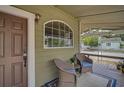Inviting front porch with wicker seating, perfect for relaxing outdoors at 301 W South Ave, Tampa, FL 33603