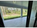 Covered patio offers a serene view of the lush green backyard and provides a perfect outdoor living space at 3386 Irma St, North Port, FL 34291