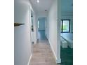 Hallway boasting tile floors that lead to a sun-filled living room at 3398 Escobar Ln, North Port, FL 34286