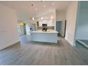 Bright, open-concept kitchen with stainless steel appliances, marble countertops, and large island at 3398 Escobar Ln, North Port, FL 34286