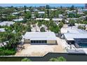 Beautiful home with canal access and a screened patio, nestled in a lush, waterfront community at 385 Avenida Madera, Sarasota, FL 34242