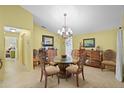Bright dining area with tile flooring, a chandelier, and decorative furnishings at 4109 Carriage Dr # 23, Sarasota, FL 34241
