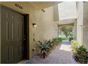 View of the front door to unit 4204 and its brick-paved walkway and colorful landscaping at 4204 Overture Cir # 4204, Bradenton, FL 34209