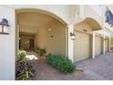 View of garage entrance to unit 4204 with brick pavers and decorative landscaping at 4204 Overture Cir # 4204, Bradenton, FL 34209