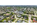 A panoramic aerial perspective of the property surrounded by lush trees, in a neighborhood and close to town at 4308 Kingston Loop, Sarasota, FL 34238