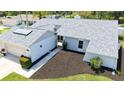 An elevated view of this charming home, featuring well-maintained landscaping, an attached two-car garage, and a stylish gray roof at 4308 Kingston Loop, Sarasota, FL 34238
