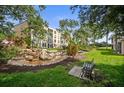 Landscaped grounds, rock-lined pond and bench seating area in front of the building at 4530 Pinebrook Cir # 109, Bradenton, FL 34209