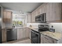 Well-lit kitchen with stainless steel appliances and granite countertops, perfect for cooking and entertaining at 4530 Pinebrook Cir # 109, Bradenton, FL 34209