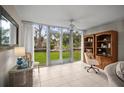 Office space featuring large sliding doors to backyard, tile floors and built in shelving at 4530 Pinebrook Cir # 109, Bradenton, FL 34209