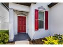 Inviting front entry with a striking red door and modern architectural details that welcomes you home at 4739 Reisswood Loop, Palmetto, FL 34221