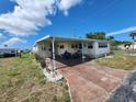Inviting single-story home featuring a covered carport and a well-maintained driveway for easy access at 5301 Algeria Ct, Bradenton, FL 34207