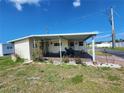 Charming single-story home with a covered carport and cozy front yard, offering a welcoming curb appeal at 5301 Algeria Ct, Bradenton, FL 34207