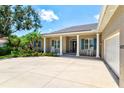 Charming home showcasing a front porch with stately columns and beautiful landscaping at 5373 Anthony Ln, Sarasota, FL 34233