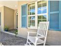 Close up of the front porch with rocking chair and blue shutters at 5373 Anthony Ln, Sarasota, FL 34233
