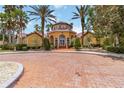 Stunning clubhouse with a circular design, grand entrance, and manicured landscaping at 5401 Bentgrass Dr # 1-113, Sarasota, FL 34235