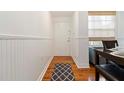 Charming entryway with hardwood floors, wainscoting, and a dining area at 5401 Bentgrass Dr # 1-113, Sarasota, FL 34235