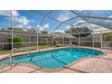 Inviting screened-in pool with refreshing blue water, perfect for relaxation and outdoor entertaining at 5613 Sweetwater Oak Dr, Sarasota, FL 34232