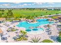 Resort-style pool area featuring waterfalls, lounge chairs, umbrellas, and lush landscaping at 5624 Palmer Cir # 206, Bradenton, FL 34211