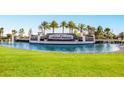 Lakewood National entrance sign surrounded by water, lush lawn, and palm trees at 5624 Palmer Cir # 206, Bradenton, FL 34211