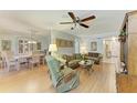 Comfortable living room adjacent to dining area with hardwood floors and ceiling fan at 6108 7Th W Ave # 6108, Bradenton, FL 34209